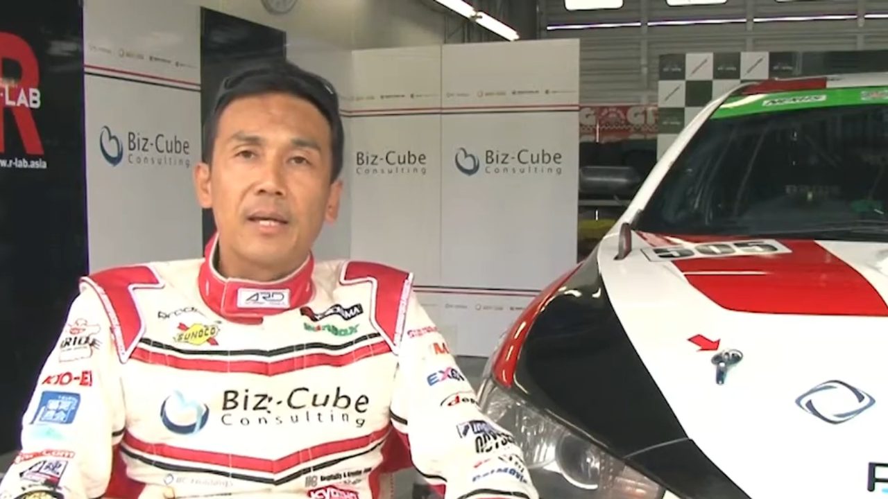 Shozo Tagahara beside the #505 Mitsubishi Lancer race car, 2016